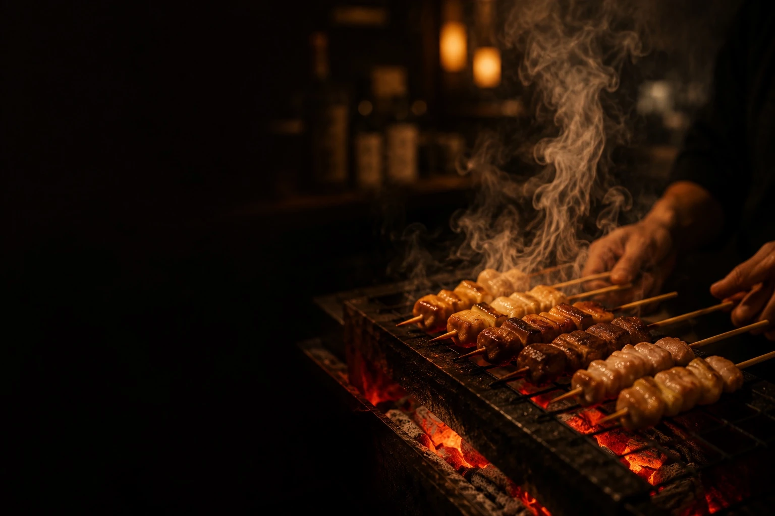 Yakitori skewers grilling over charcoal at Sumibi Hirashima, Thonglor, Bangkok
